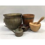 A banded ice bucket, a bear carved pestle and mortar, another wooden bowl and a brass moulded coal