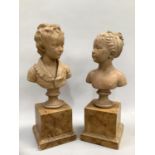 A pair of terracotta busts of a young girl and boy each raised on a sockel and faux marble plinth of