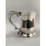 A silver half pint tankard, baluster form with c-scroll handle on circular foot, Hallmark for