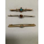 Three early 20th century bar brooches, all in 9ct gold and variously set with opal, citrinin and
