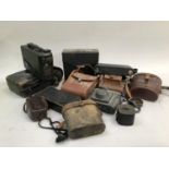 A quantity of cameras to include Kodak Model B, Kodak brownie, another in leather case, Kodak colour