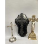 A gilt wood and porcelain crucifix, a silver plated crucifix on domed base, and an ebonised cross