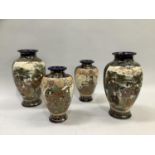 A pair of Japanese vases of baluster form with flared rims decorated with two large panels of