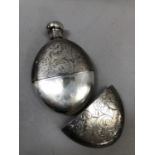A 19th century silver plated spirit flask, the oval body and cover engraved with a lion rampant