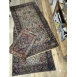 A pair of Persian style rugs, the ivory ground woven with a design of blossom in blue, rose, ochre