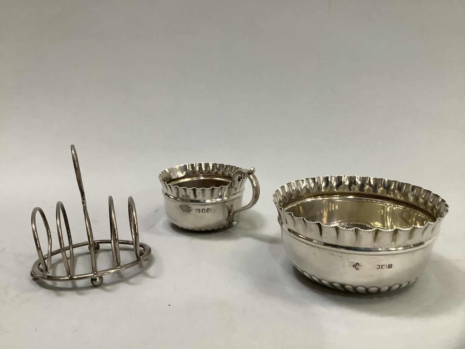 A late Victorian silver sugar and cream, London 1896 together with an individual five-bar toast