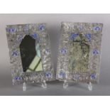A PAIR OF ANTIQUE PERSIAN SILVER COVERED WALL MIRRORS, of rectangular panel form with arched