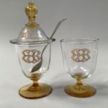 A FRENCH AMBER AND CLEAR GLASS PRESERVE POT AND DOMED COVER AND AN OPEN SALT, both enamelled with