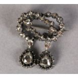 A BOW BROOCH SET WITH 17TH CENTURY ROSE CUT DIAMONDS in closed silver cut down setting including two