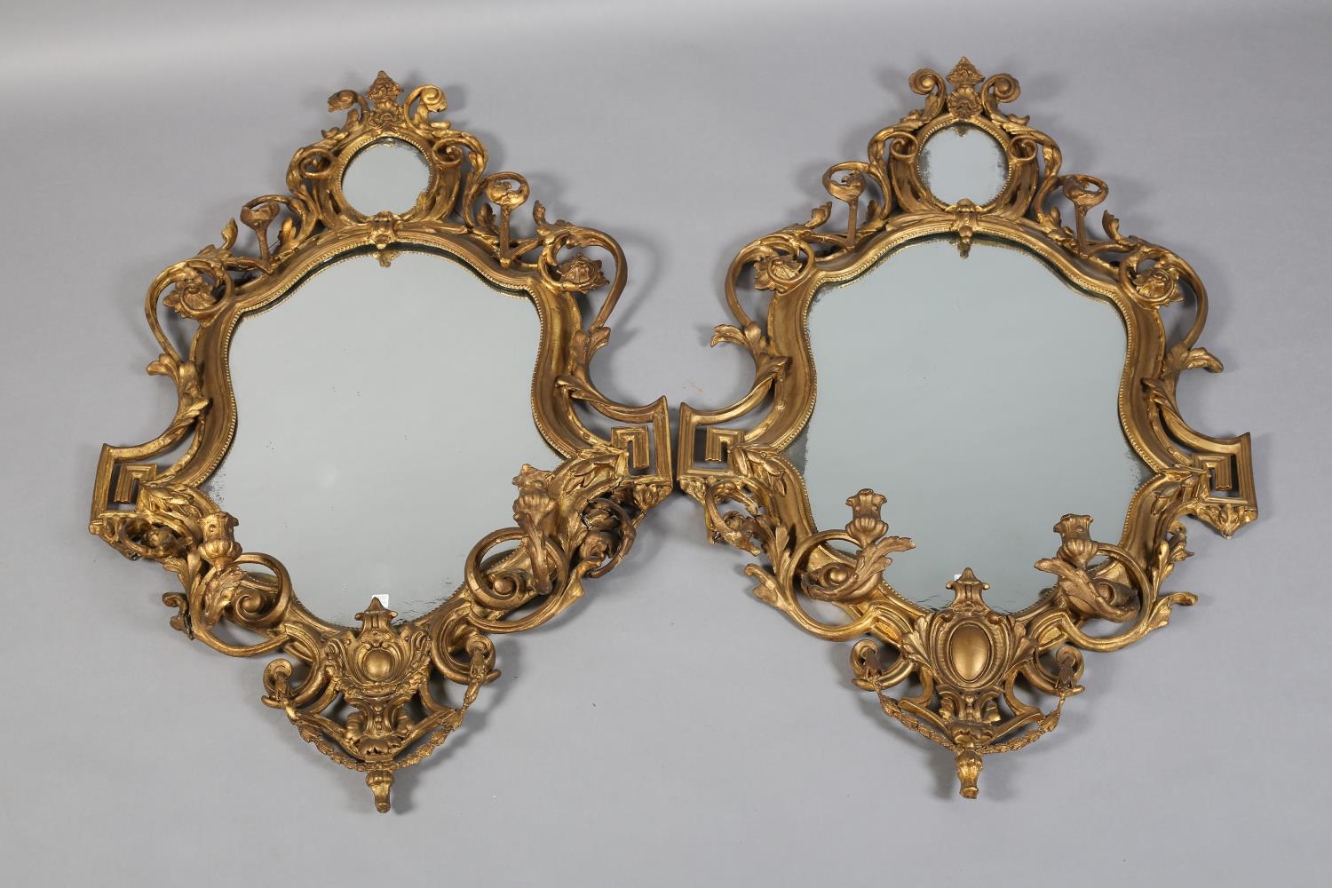 A PAIR OF 19TH CENTURY GILTWOOD AND GESSO GIRANDOLES, with twin candle sconces, the shield shape