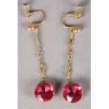 A PAIR OF EDWARD VII EAR PENDANTS set with pink paste in 9ct gold, the circular faceted stones