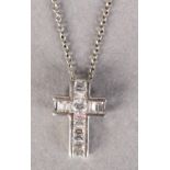 A DIAMOND SET CROSS set to the centre with a brilliant cut stone flanked by channel set baguette cut