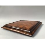 A 19TH CENTURY ROSEWOOD AND SATINWOOD GAMES BOARD, with stepped frame, the underside with baise
