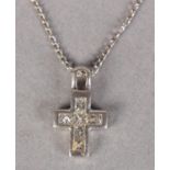 A DIAMOND SET CROSS, the princess cut stones channel set in white metal (tests as 18ct gold) hung on