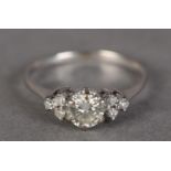 A DIAMOND RING IN 18CT WHITE GOLD, claw set to the centre with a brilliant cut stone, flanked by
