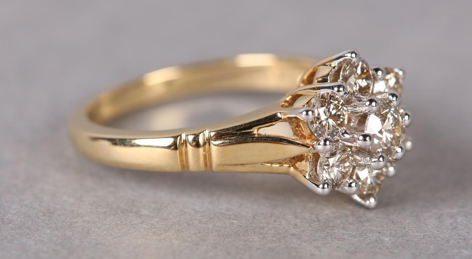 A DIAMOND CLUSTER RING the brilliant cut stones claw set within a circular outline flanked by - Image 2 of 3