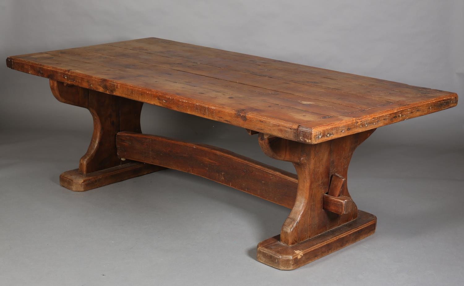 AN EARLY 20TH CENTURY FRENCH PINE REFECTORY DINING TABLE, the planked top with cleat ends, on