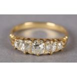 A VICTORIAN FIVE STONE DIAMOND RING in 18ct gold, the graduated Old European cut stones claw set
