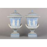 A PAIR OF LATE 18TH CENTURY WEDGWOOD JASPERWARE URNS AND COVERS, of campana form in pale blue,