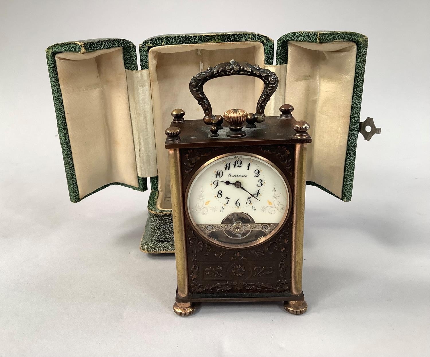 AN EARLY 20TH CENTURY FRENCH TRAVEL CLOCK with 8 day jewelled lever movement, the enamel dial with