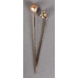 A VICTORIAN PEARL AND DIAMOND STICK PIN, the gilt tinted baroque pearl mounted over a collar set