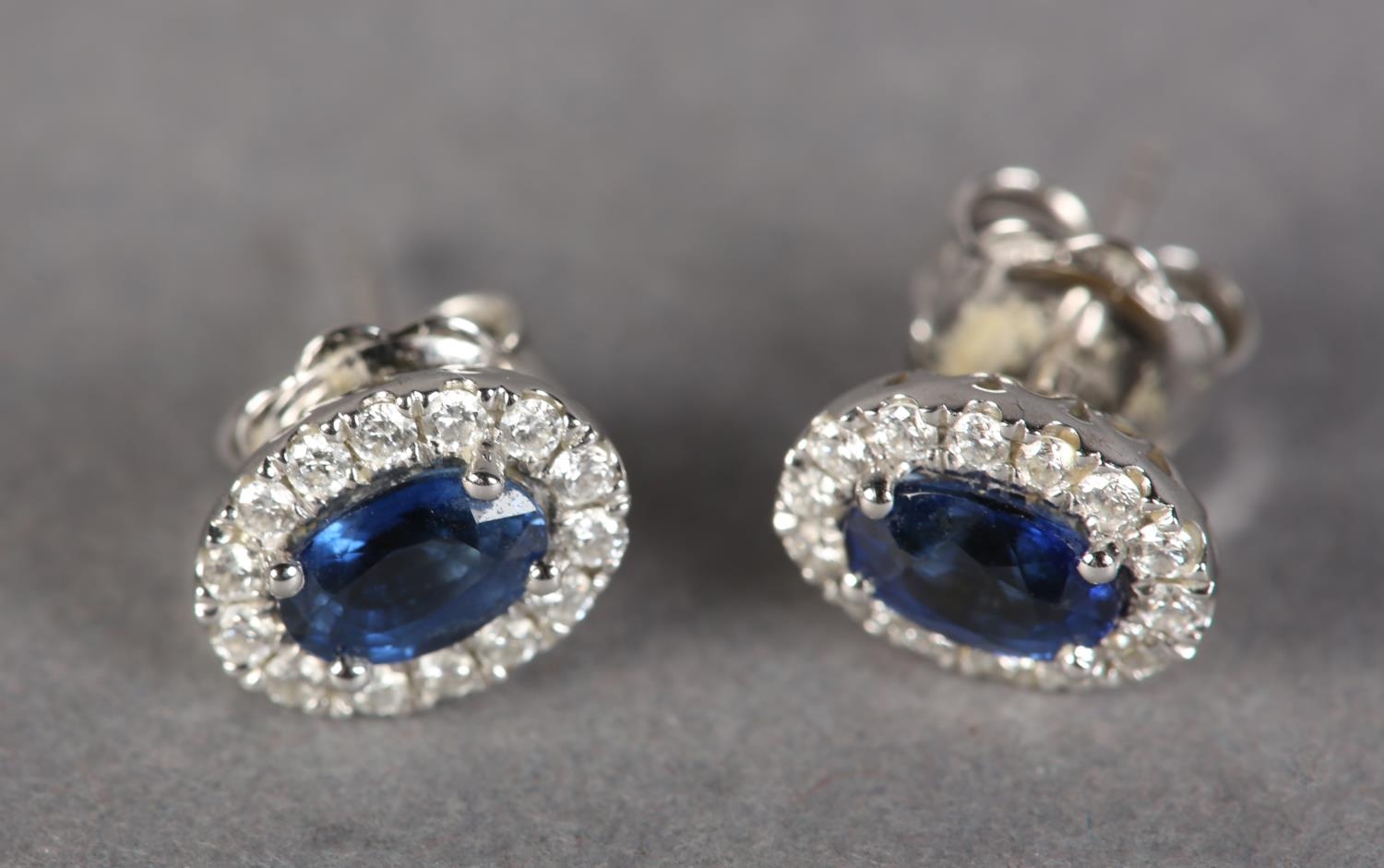 A PAIR OF SAPPHIRE AND DIAMOND CLUSTER EARRINGS in 18ct white gold, each claw set to the centre with - Image 3 of 3