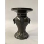A JAPANESE BRONZE VASE, Meiji period, baluster form with elephant mask handles, a collar of cast