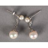 A PAIR CULTURED PEARL AND DIAMOND EARRINGS in 9ct white gold, each 7.5mm pearl in a crenulated cup