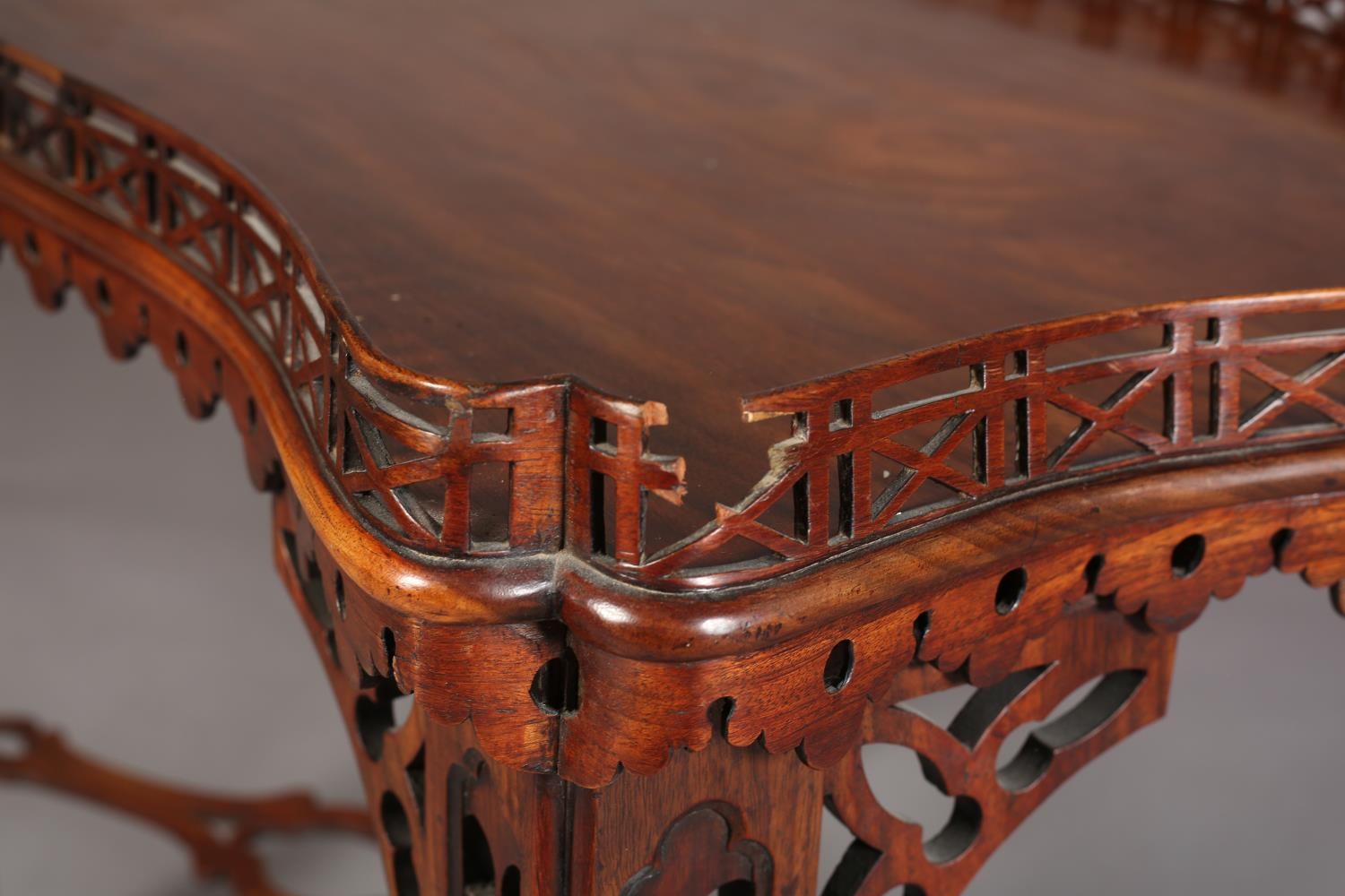 A GEORGE III MAHOGANY TEA TABLE of rectangular serpentine outline with fretwork gallery apron, angle - Image 6 of 6