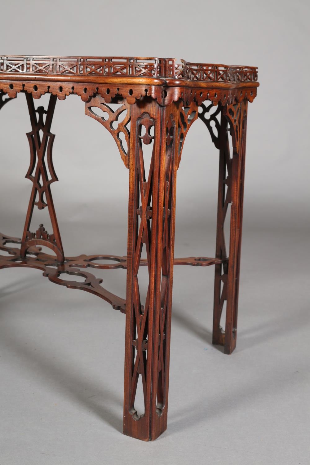 A GEORGE III MAHOGANY TEA TABLE of rectangular serpentine outline with fretwork gallery apron, angle - Image 3 of 6