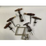 SEVEN 19TH CENTURY CORKSCREWS comprising Heeley’s nickel ‘Pullezi’, three with fruitwood handles and