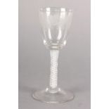 AN 18TH CENTURY WINE GLASS, the bucket bowl engraved with grapevine, on a double series opaque twist