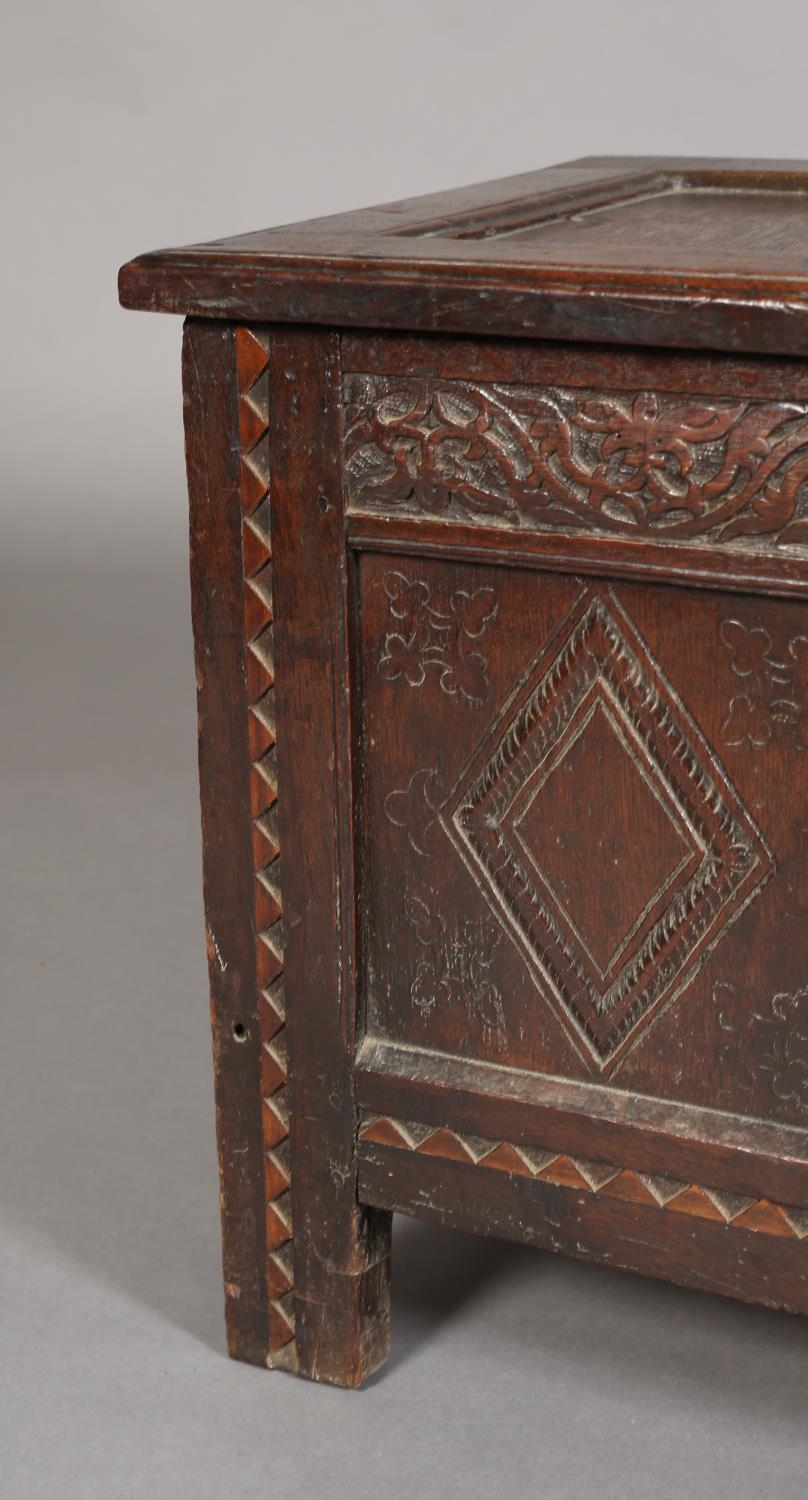 A LATE 17TH CENTURY OAK KIST HAVING A TRIPLE INDENTED TOP, the frieze intricately carved with - Image 7 of 7