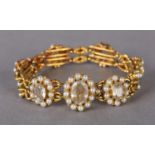 A VICTORIAN ROCK CRYSTAL AND SEED PEARL BRACELET in 18ct gold, each oval cluster link collet set