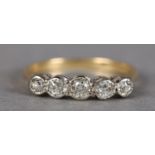 A FIVE STONE DIAMOND RING, the graduated old European cut stones illusion set in line in yellow