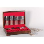AN ELIZABETH II SILVER CANTEEN OF CUTLERY BY COOPER BROTHERS, scroll ends pattern consisting of