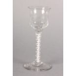 A MID 18TH CENTURY WINE GLASS, the ogee bowl part honeycomb and waisted, on double series opaque