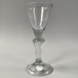 AN 18TH CENTURY WINE GLASS, the funnel bowl on a solid collar and Silesian stem, with conical folded