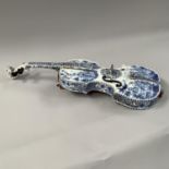A 19TH CENTURY FRENCH FAIENCE MODEL OF A VIOLIN finely painted in blue and white, in the 18th