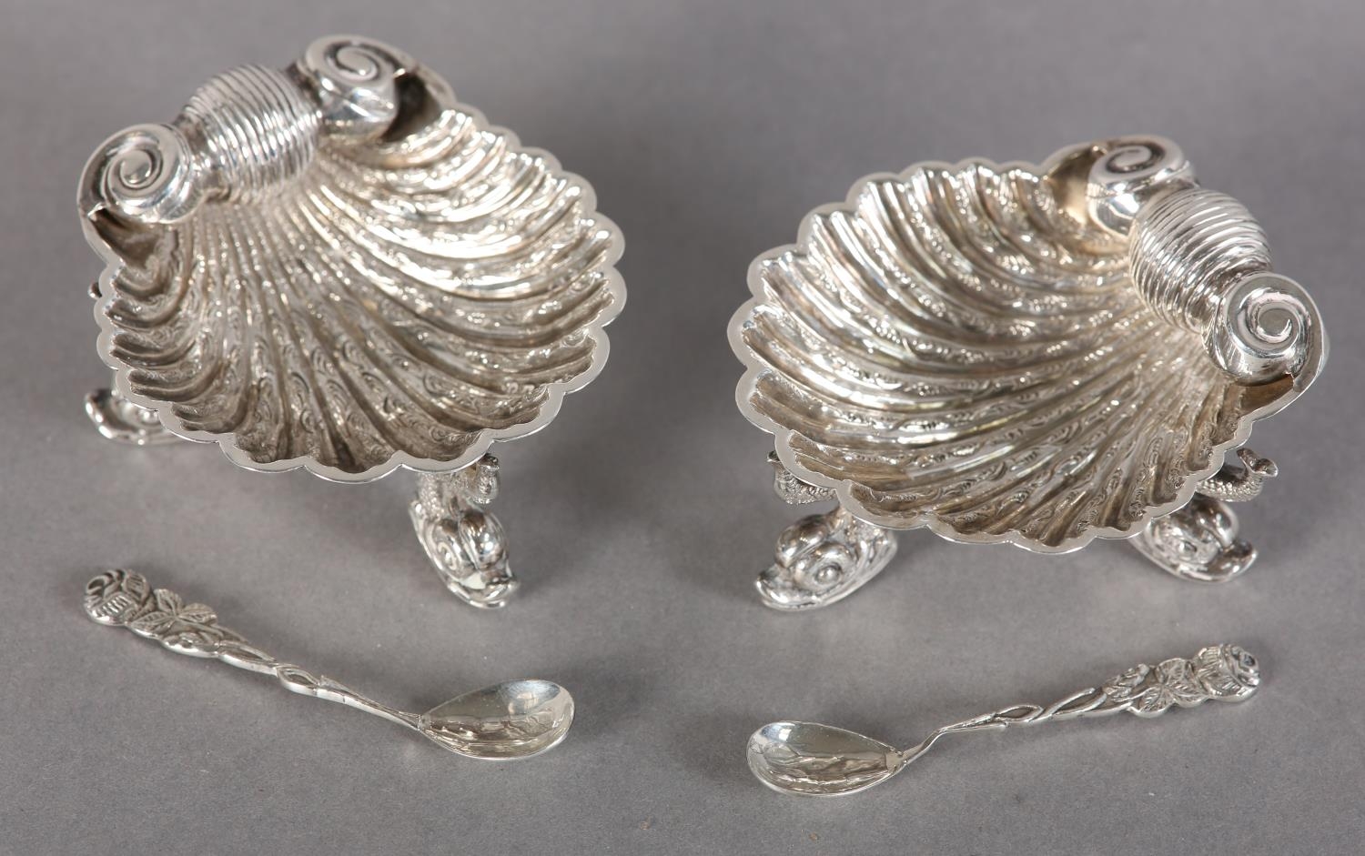 A PAIR OF VICTORIAN SILVER SCALLOP SHELL SALTS, each scroll chased on three dolphin feet, hallmarked