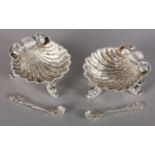 A PAIR OF VICTORIAN SILVER SCALLOP SHELL SALTS, each scroll chased on three dolphin feet, hallmarked