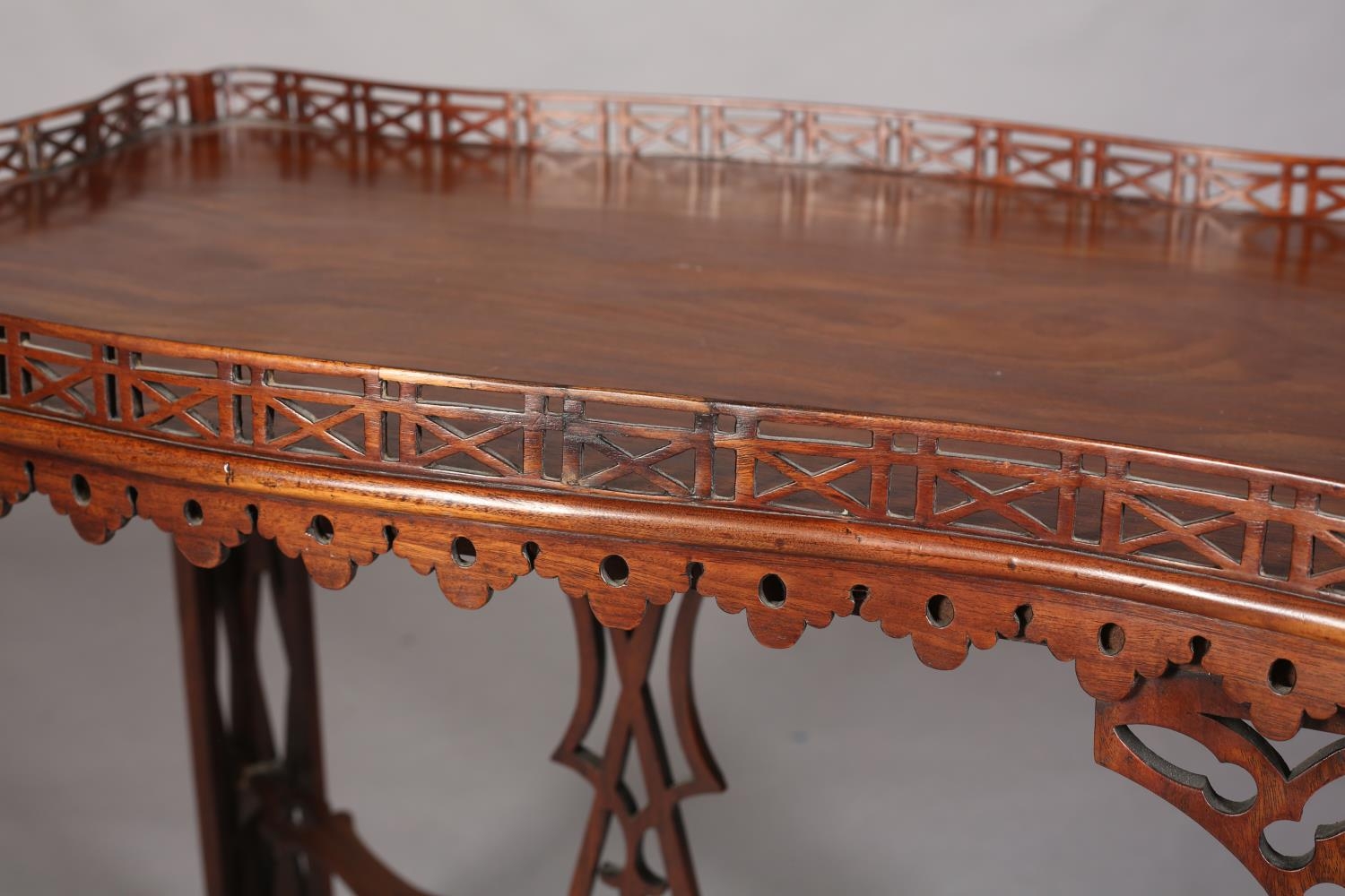 A GEORGE III MAHOGANY TEA TABLE of rectangular serpentine outline with fretwork gallery apron, angle - Image 5 of 6