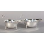 A PAIR OF GEORGE V SILVER SAUCEBOATS, Birmingham 1928, Adie Bros., with bracketed rims and on