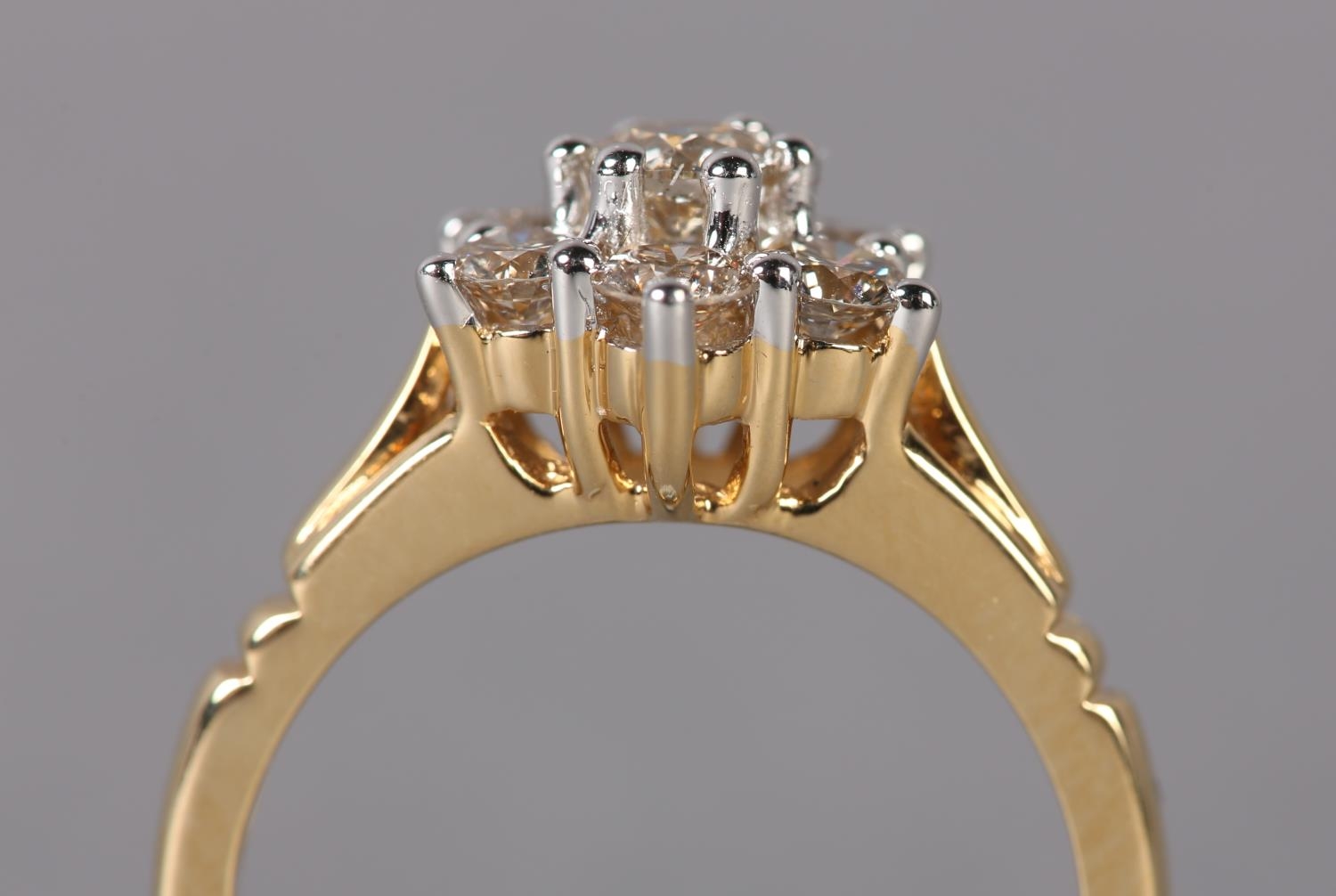 A DIAMOND CLUSTER RING the brilliant cut stones claw set within a circular outline flanked by - Image 3 of 3