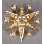 A VICTORIAN DIAMOND AND SEED PEARL STAR BROOCH IN 15CT GOLD, set to the centre with an Old
