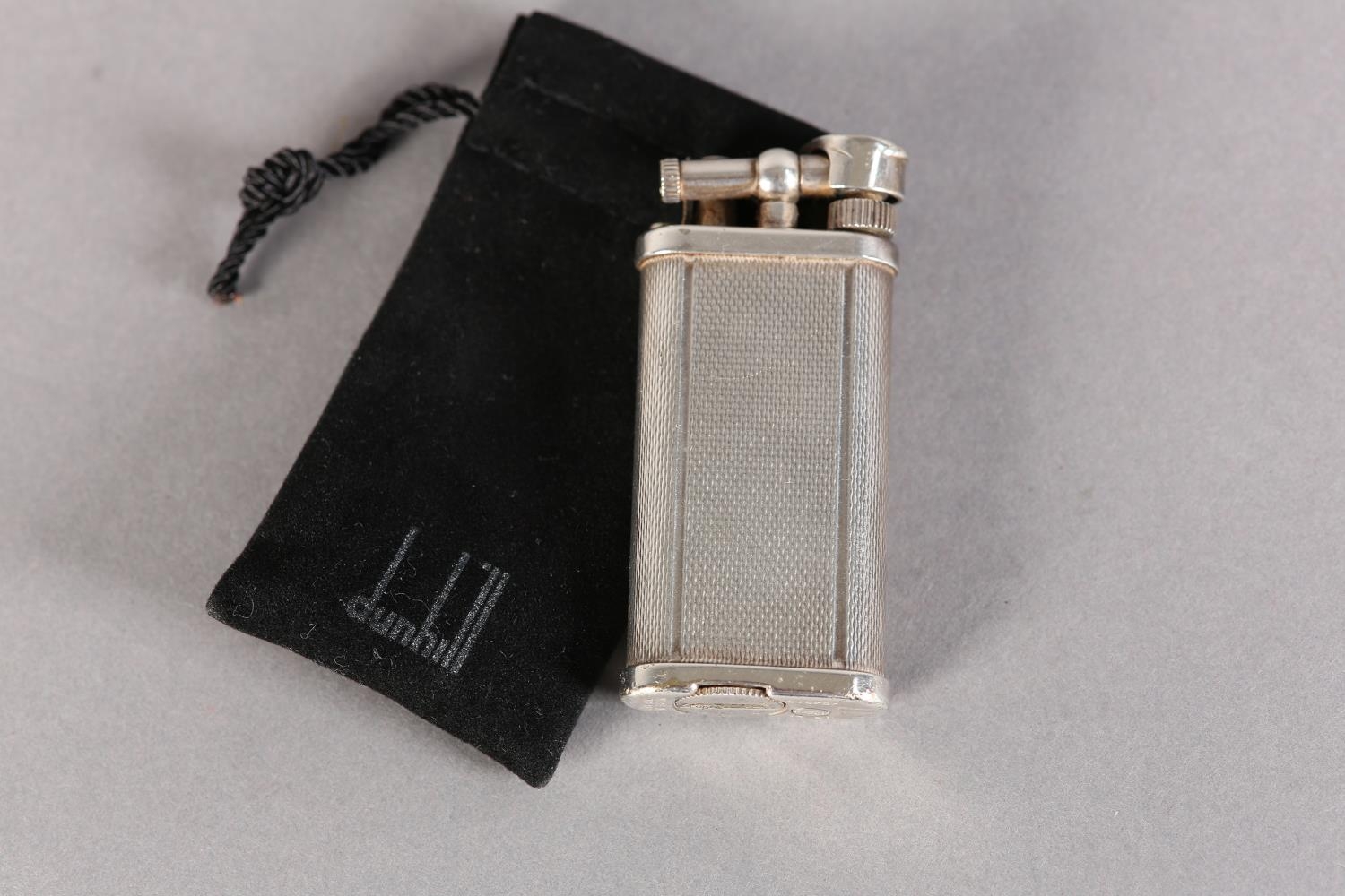 A DUNHILL 'UNIQUE' LIFT ARM PETROL LIGHTER No. 484316 engine turned, silver plated, signed and