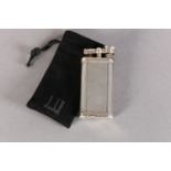 A DUNHILL 'UNIQUE' LIFT ARM PETROL LIGHTER No. 484316 engine turned, silver plated, signed and