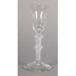 A MID 18TH CENTURY WINE GLASS, the bell bowl on a double knopped air twist stem with conical foot,