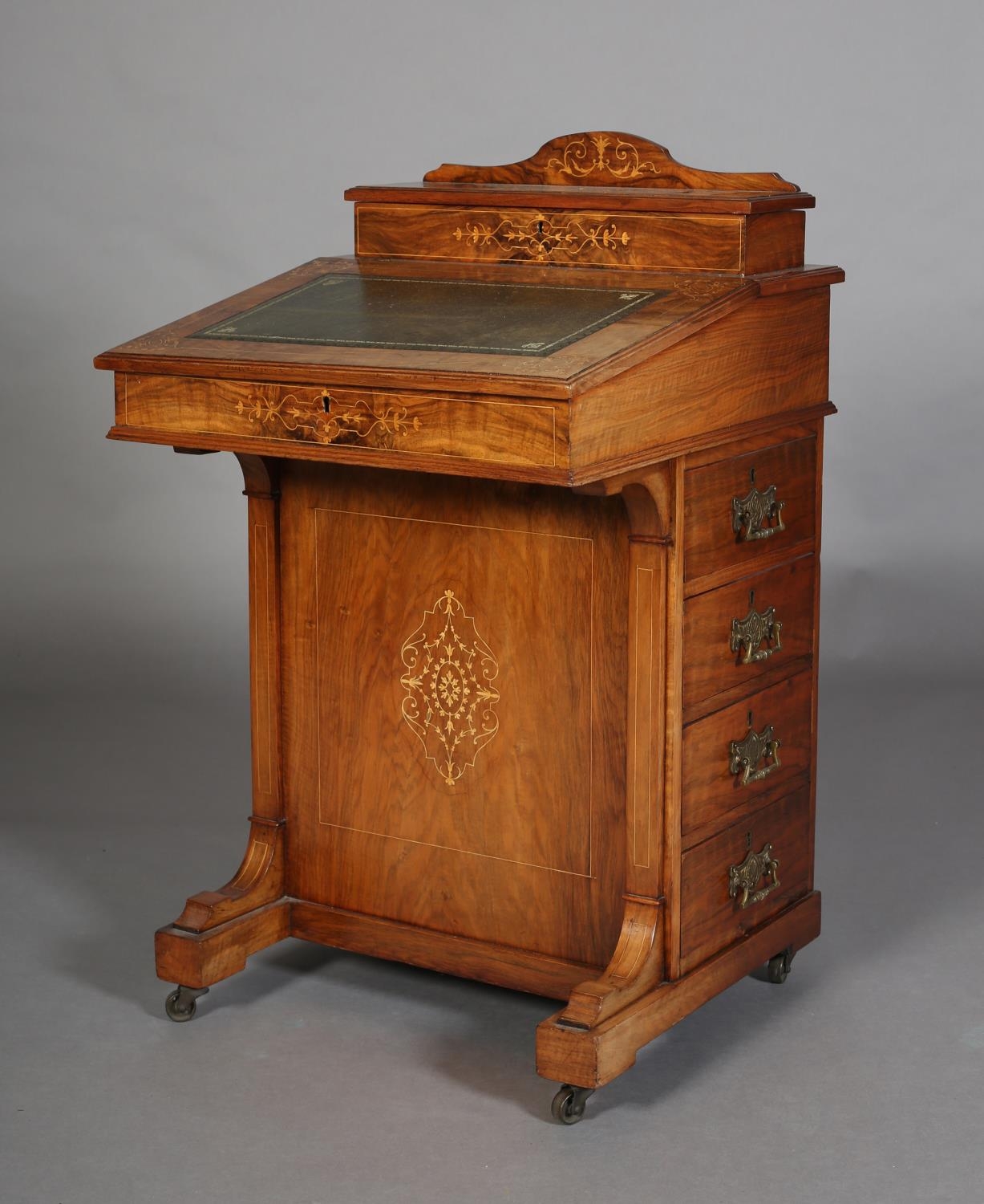 A 19TH CENTURY FIGURED WALNUT AND SATINWOOD INLAID DAVENPORT having a raised compartment, leather