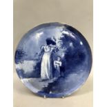 A Royal Doulton hand painted plate decorated with a scene of a woman and child in woodland with gilt